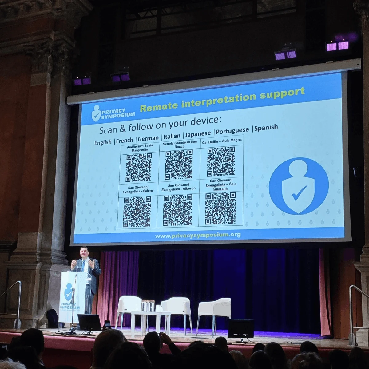 Speaker on stage at a multilingual conference